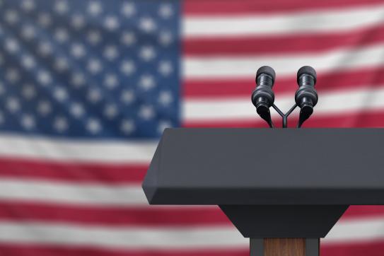 microphone on podium in front of American flag