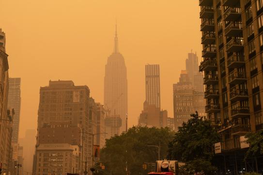 Smoke from wildfires blanketed cities many places across the Northeast and Midwest this week, leading to air quality at unhealthy levels in many regions and turning skies orange.