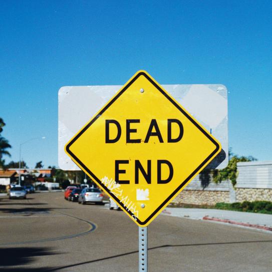 A photograph of a street sign reading "dead end"